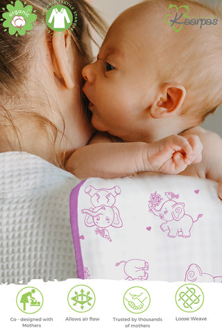 Mother burping baby using kaarpas burp cloth elephant print purple colour bib, perfectly sized to sit over mother's shoulder. 